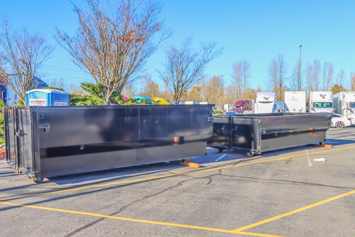 Professional dumpster rental service with roll-off container on residential driveway in Windham